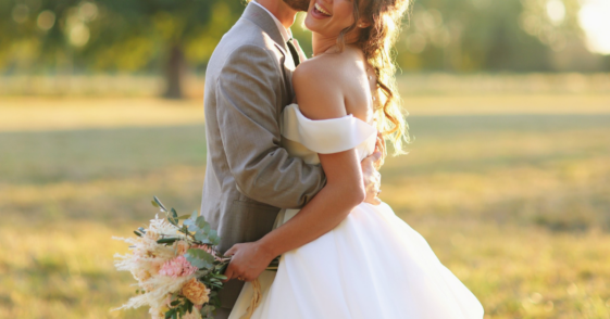 bride and groom in a field