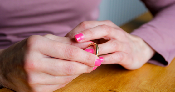 Woman taking off wedding ring