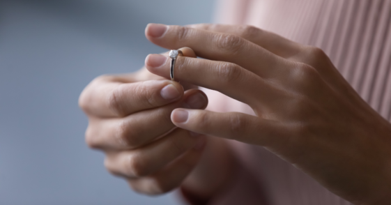 Woman taking off engagement ring