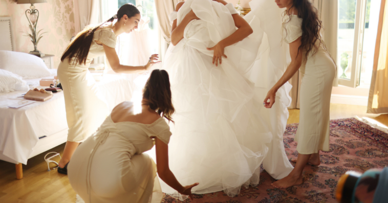 Bride getting ready in lavish wedding dress