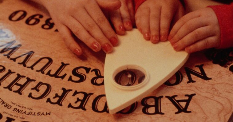 Children Play with a Ouija Board.