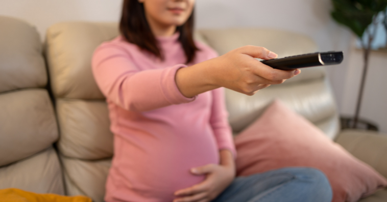 Pregnant woman watching television