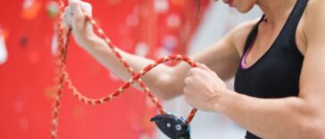 A young woman adjusts her safety harness.