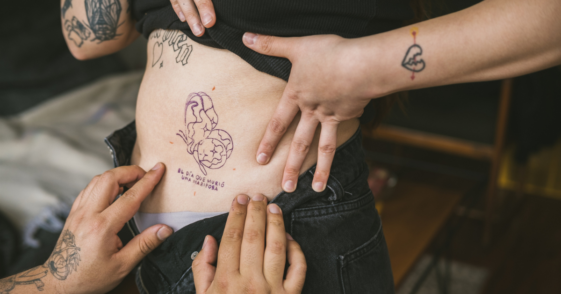 A woman showing off her tattoos