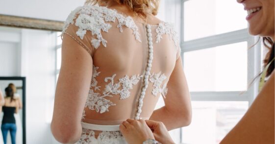 Bride trying on wedding dress