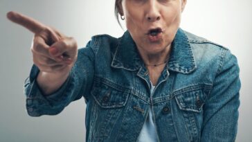 Angry elderly woman yelling and pointing