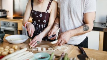 Mature couple preparing a meal in kitchen