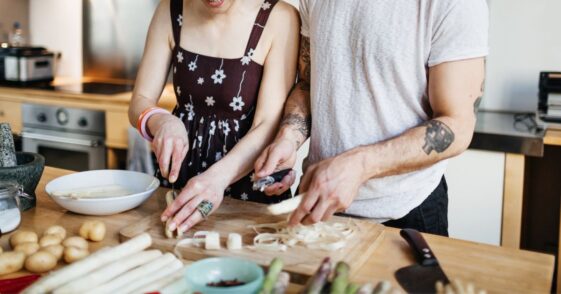 Mature couple preparing a meal in kitchen