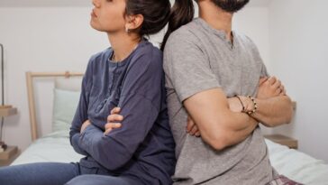 Couple with backs against each other in anger