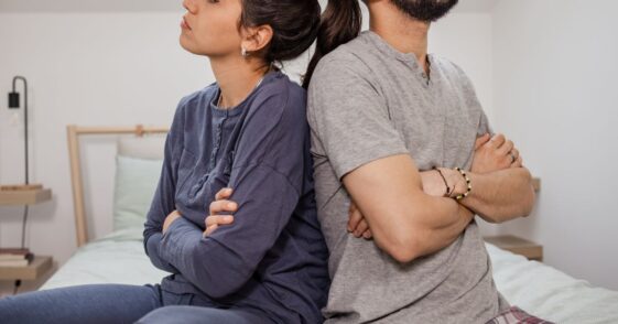 Couple with backs against each other in anger