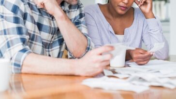 Couple reading bills at home