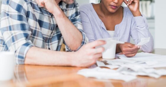 Couple reading bills at home