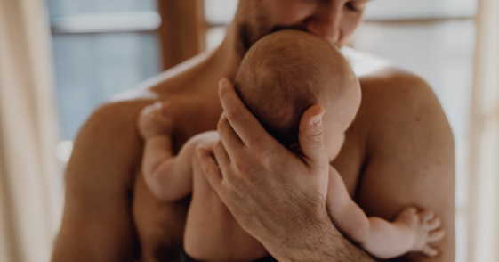 father holding an infant