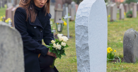 woman with flowers in cemetery