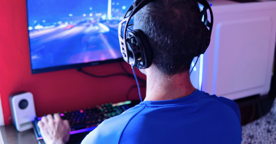 man playing games on desktop computer