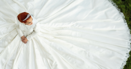 bride with wedding gown spread around her