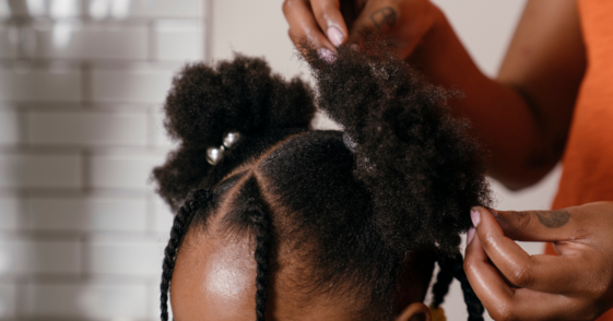 young girl getting hair styled