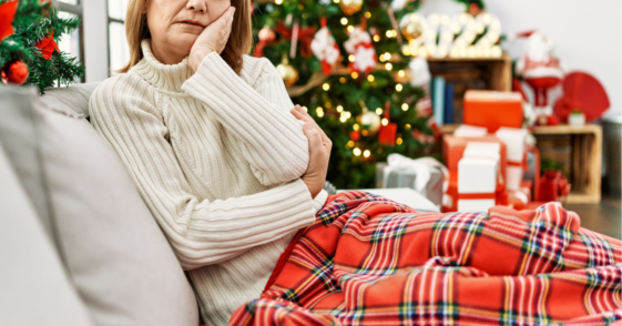 Sad woman sitting alone at Christmas