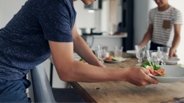 Teen boy setting the table