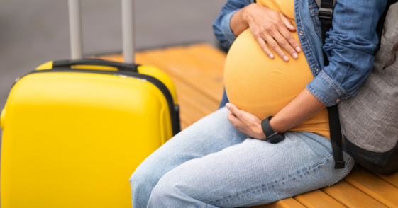 Pregnant woman with luggage