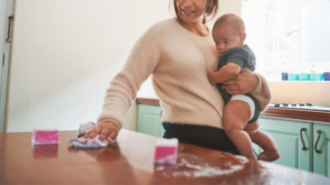 Mom cleaning and holding baby