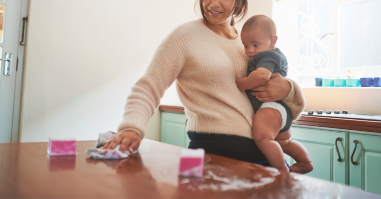 Mom cleaning and holding baby