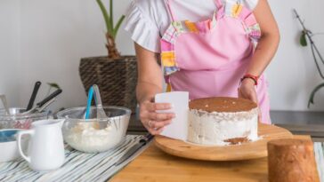 Female chef making a cake.