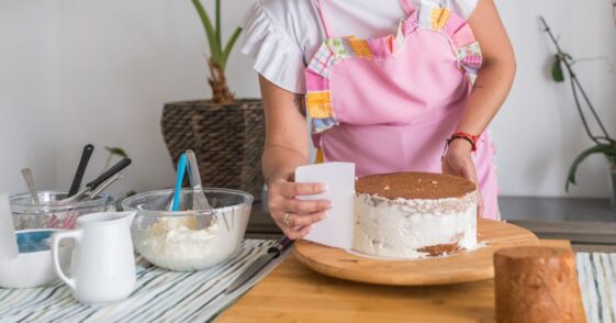 Female chef making a cake.