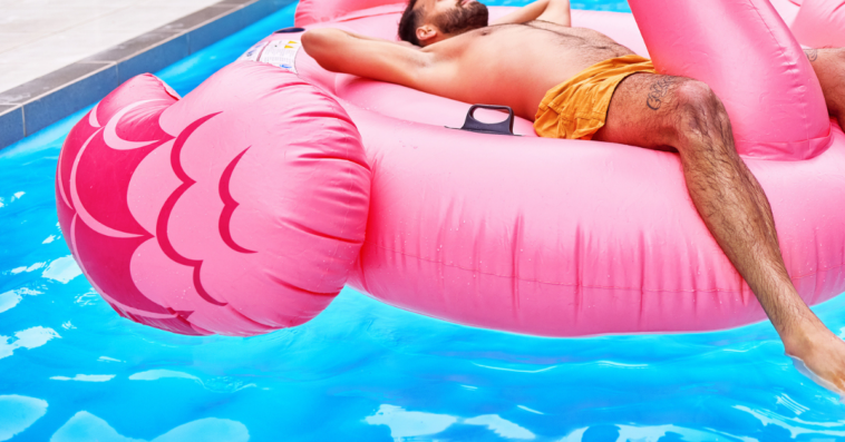 Guy relaxing at the pool