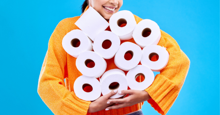 Woman holding rolls of toilet paper