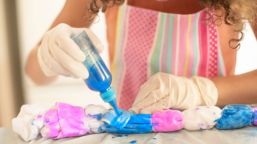 Woman tie-dyeing a dress