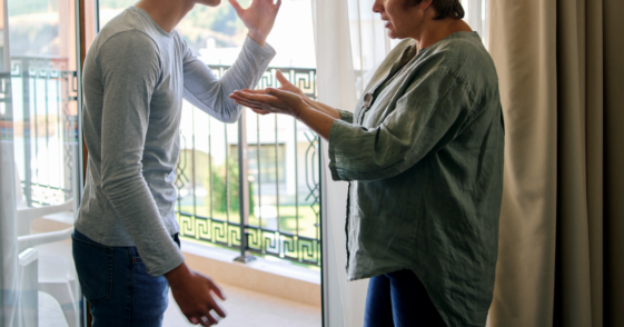 A young man and a middle aged woman having an argument.