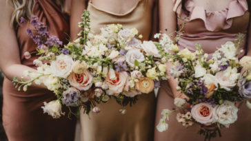 A line of bridesmaids holding. bouquets