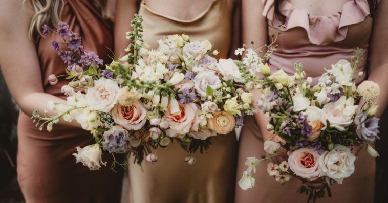 A line of bridesmaids holding. bouquets