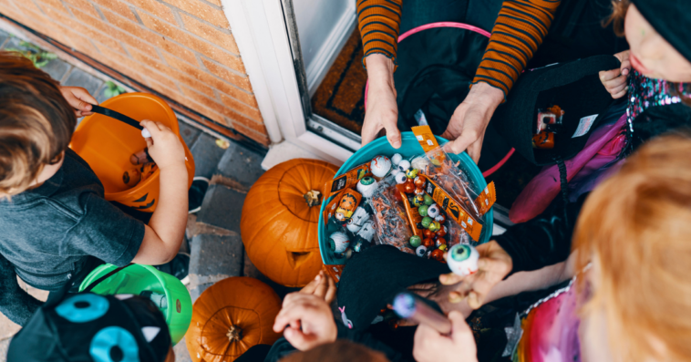 A group of children triick or treating.