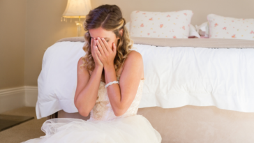 Woman crying while wearing wedding dress