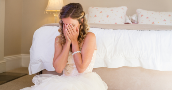 Woman crying while wearing wedding dress