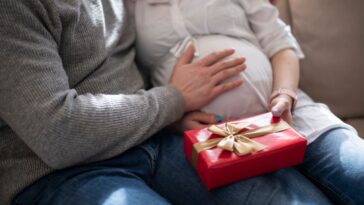 Pregnant woman holding a present from her husband