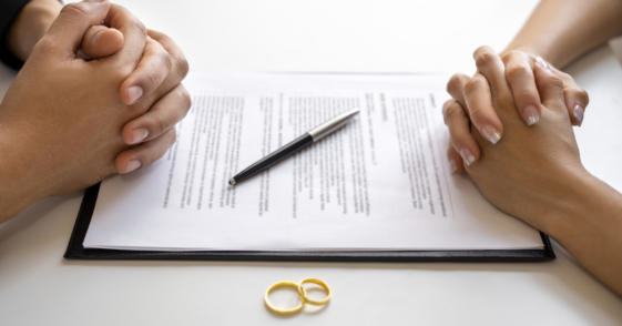 Two people signing divorce papers