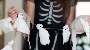 Teenager in a skeleton Trick or Treat costume