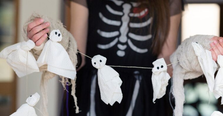 Teenager in a skeleton Trick or Treat costume