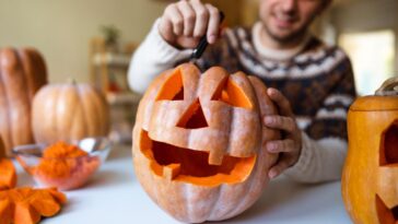 Man carving pumpkin