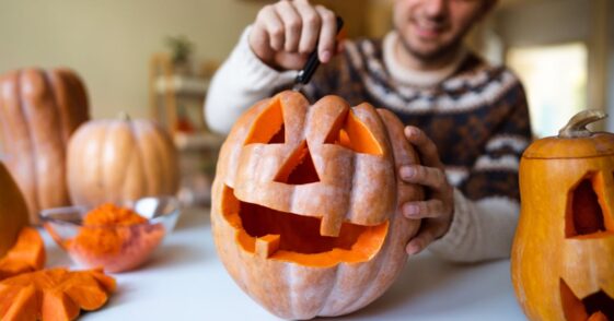 Man carving pumpkin