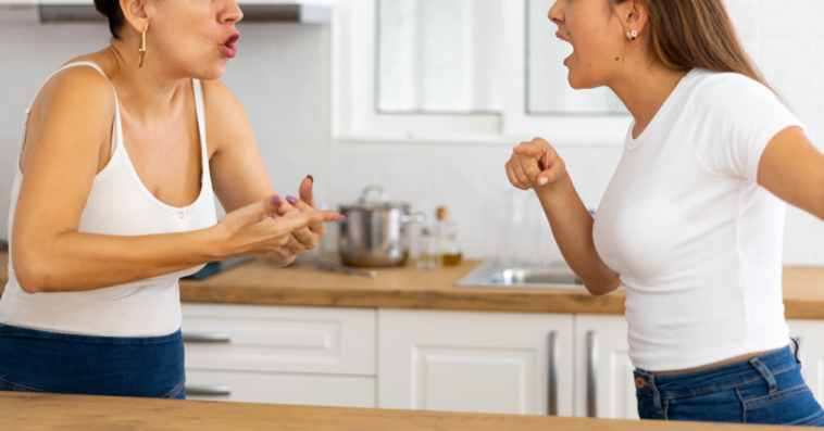 two women arguing in a kitchen