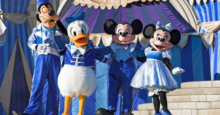 Mickey and Minnie Mouse on stage with Goofy and Donald Duck at Magic Kingdom