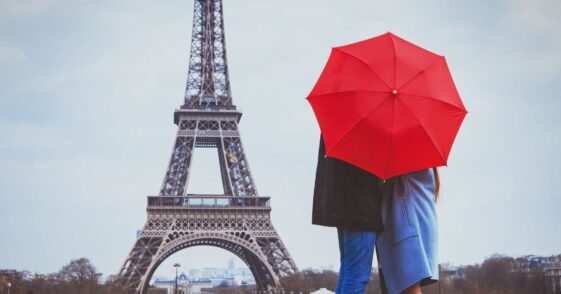 Romantic couple in Paris kissing near Eiffel towel.