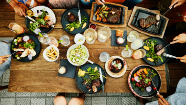 A group of people eating dinner around a table.