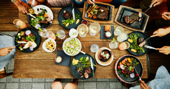 A group of people eating dinner around a table.