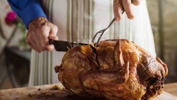 A man carving a turkey.