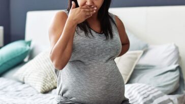 Cropped shot of a pregnant woman feeling nauseous.